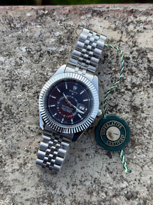 This Rolex Sky-Dweller features a prominent fluted bezel and a blue dial with a 24-hour display disc.