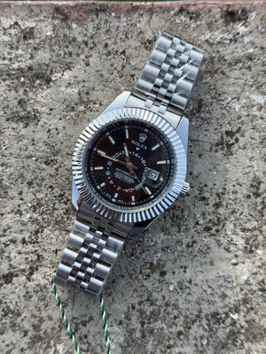 Rolex Sky-Dweller watch features a prominent fluted bezel and a black dial.