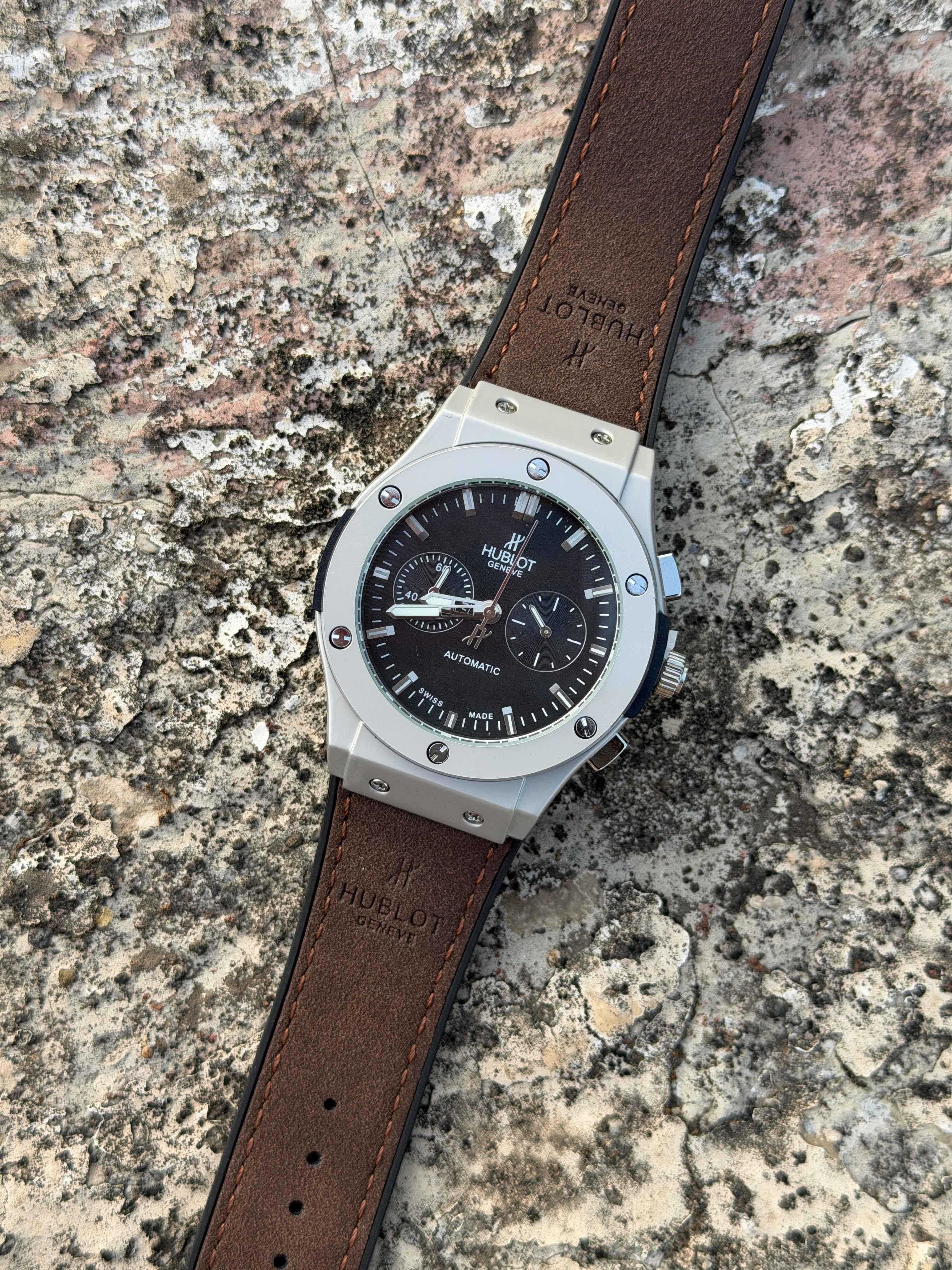 Hublot Big Bang Chronograph features a titanium case with a brown leather - OM SAI TIMEPIECE