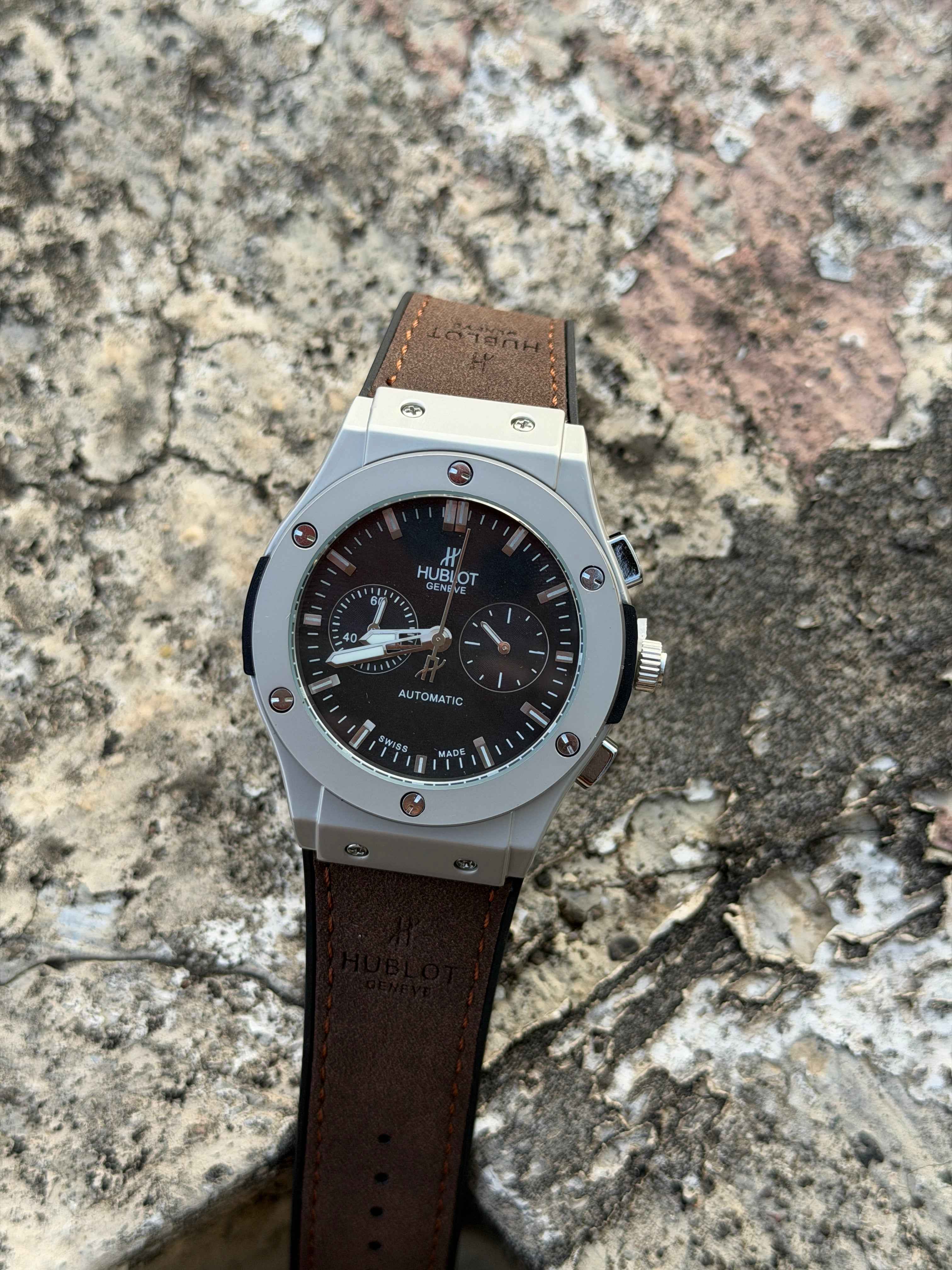 Hublot Big Bang Chronograph features a titanium case with a brown leather - OM SAI TIMEPIECE
