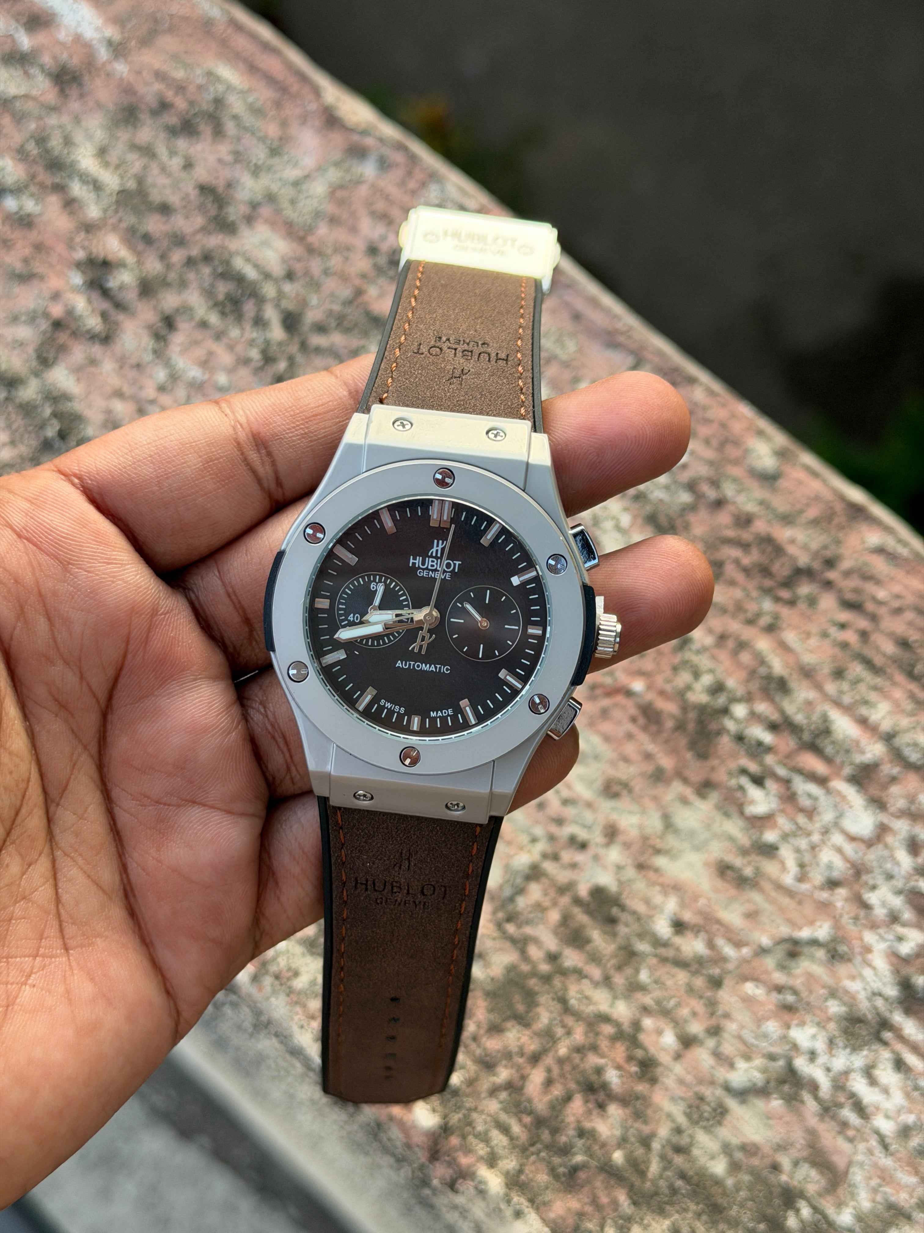 Hublot Big Bang Chronograph features a titanium case with a brown leather - OM SAI TIMEPIECE