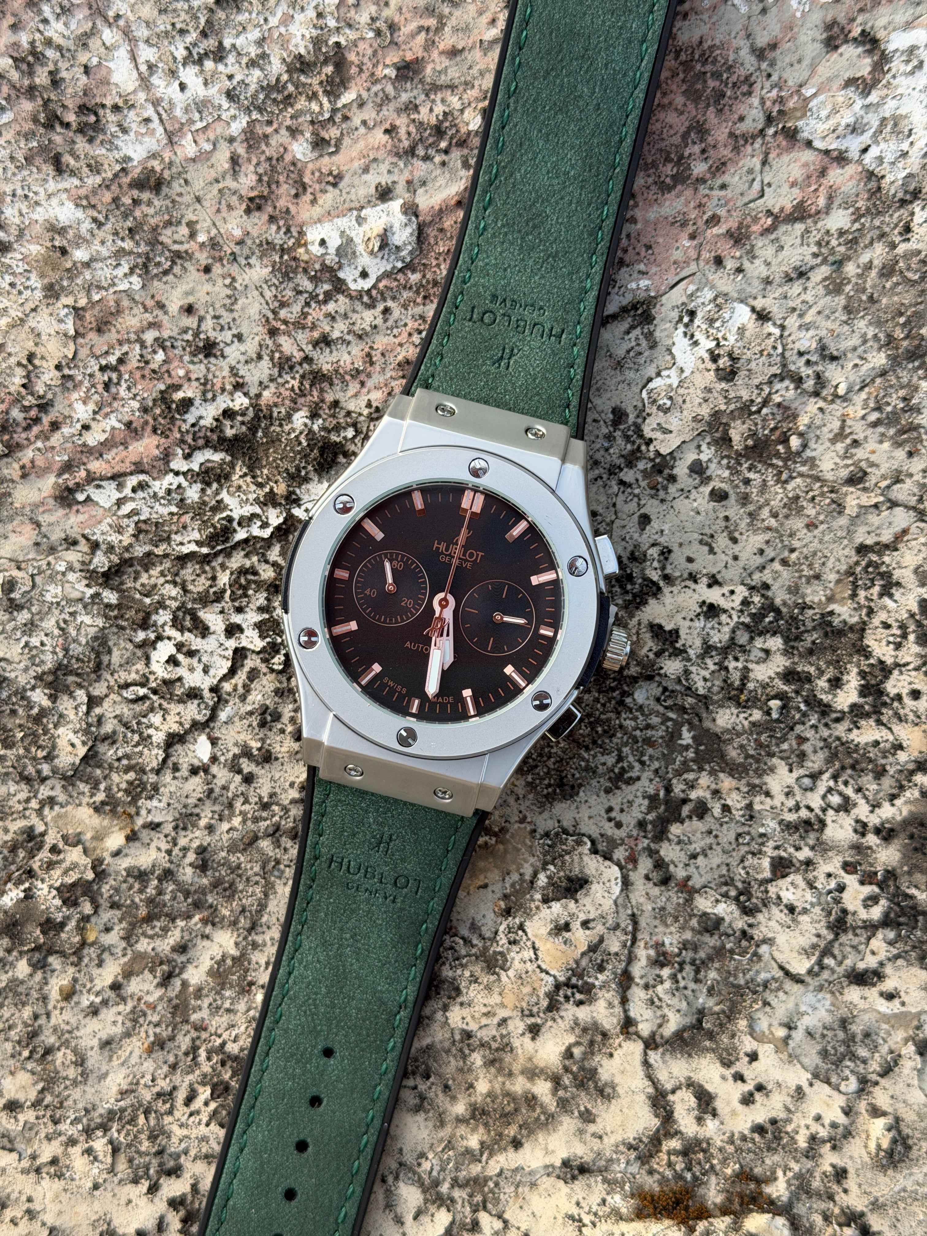 Hublot Classic Fusion Chronograph features a distinctive green - OM SAI TIMEPIECE