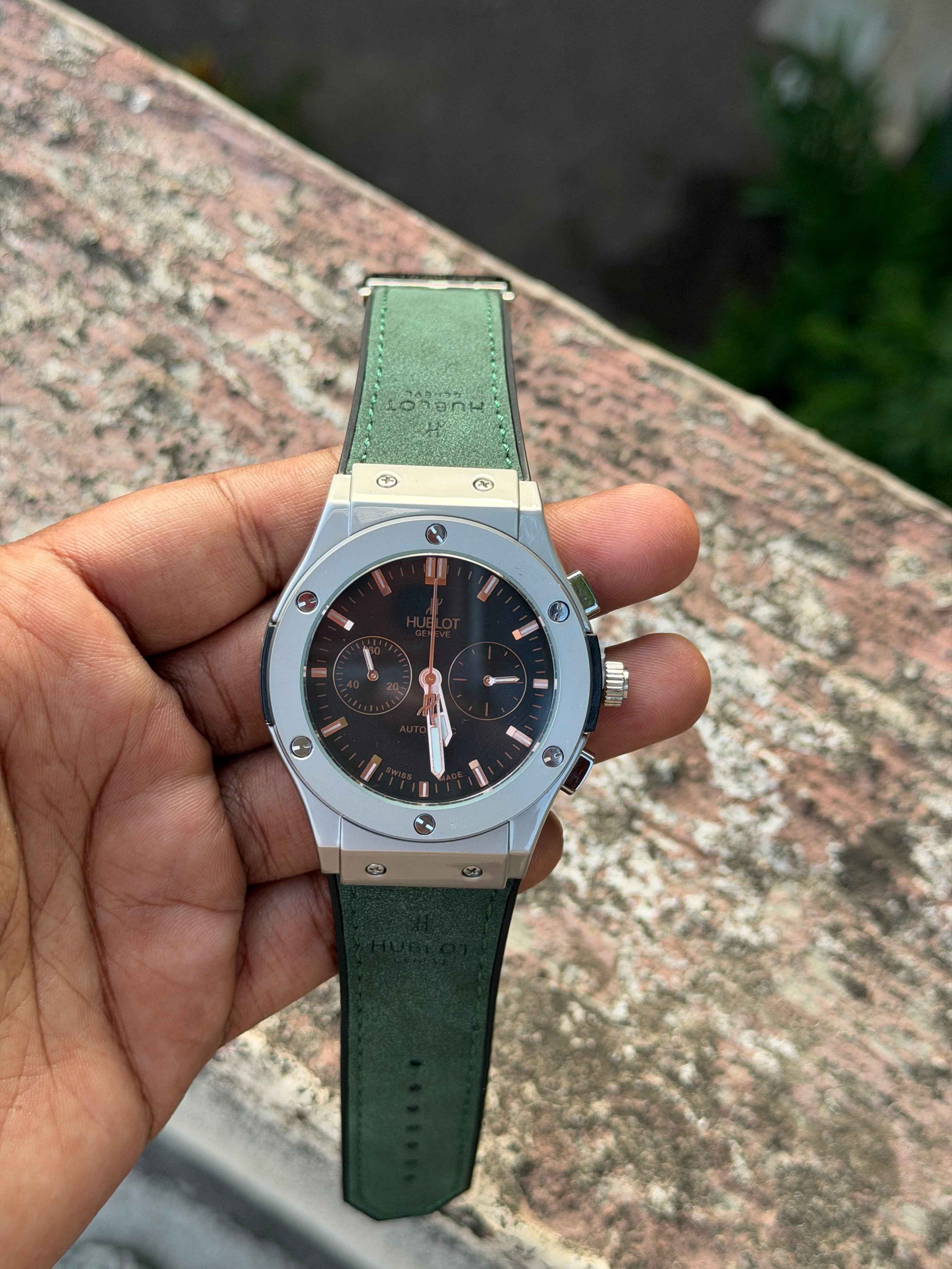 Hublot Classic Fusion Chronograph features a distinctive green - OM SAI TIMEPIECE