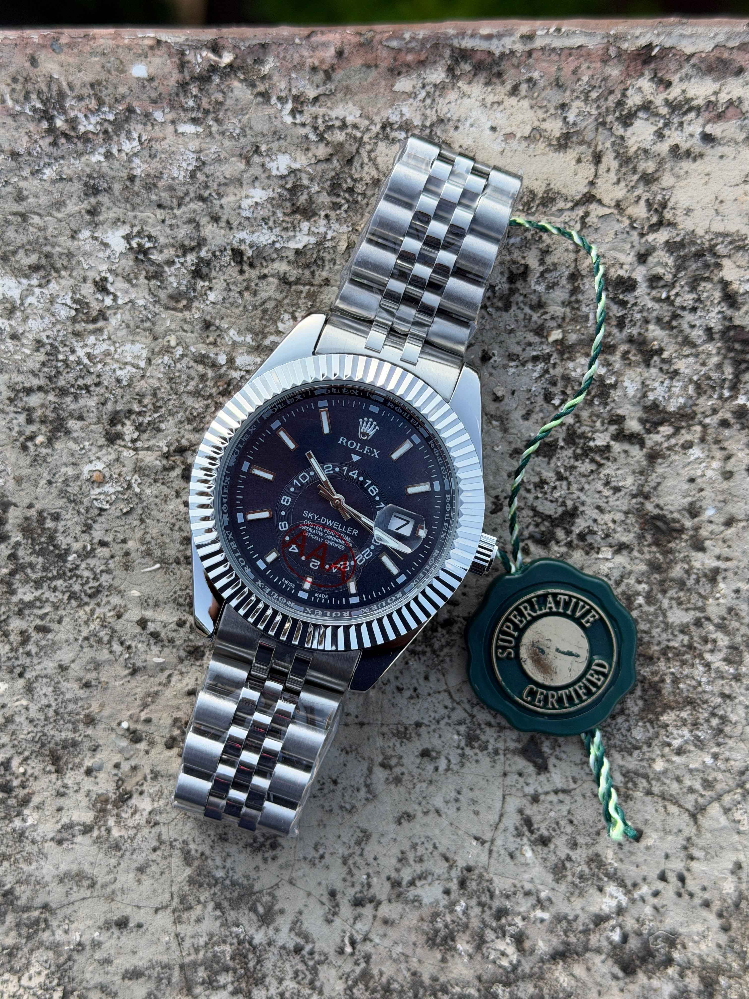 This Rolex Sky-Dweller features a prominent fluted bezel and a blue dial with a 24-hour display disc.