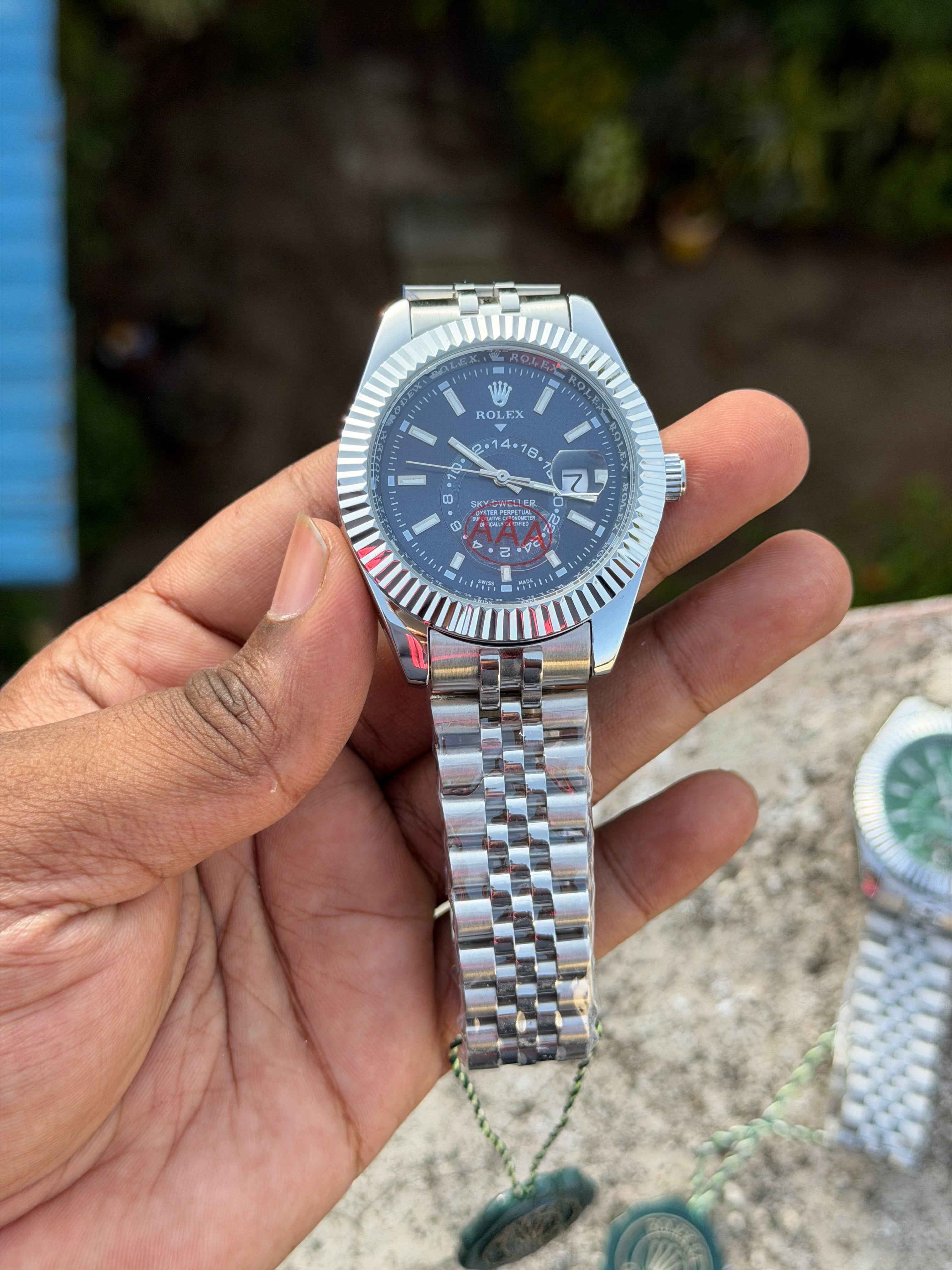 This Rolex Sky-Dweller features a prominent fluted bezel and a blue dial with a 24-hour display disc.