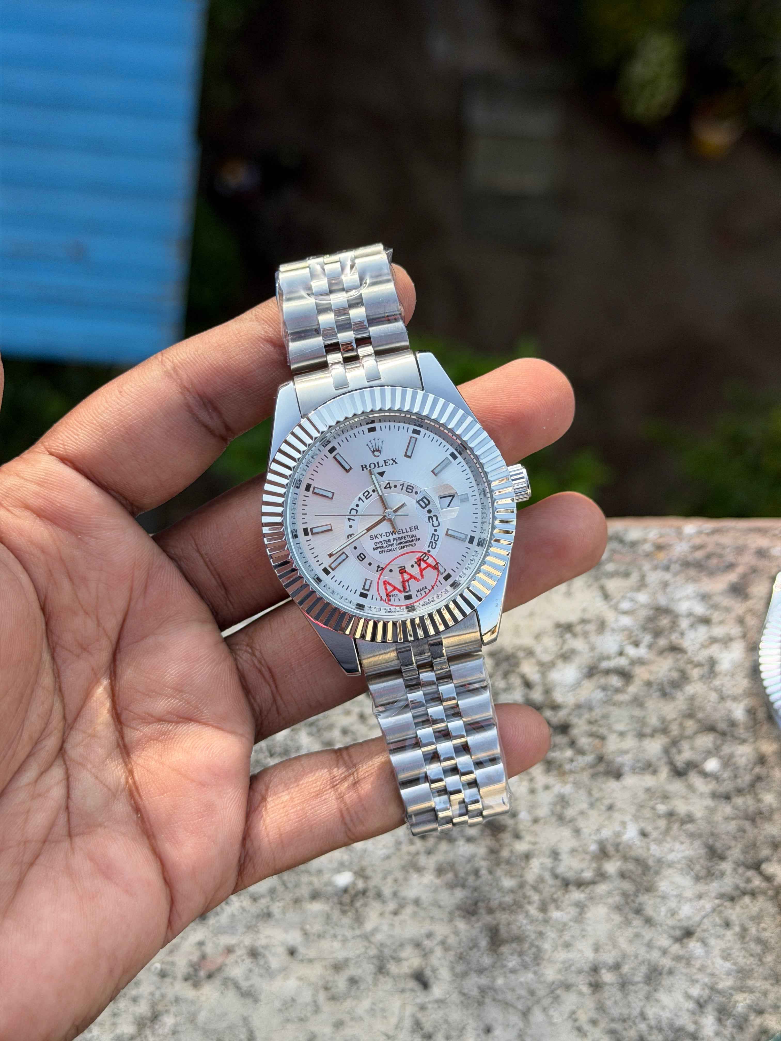 Rolex Sky-Dweller features a prominent fluted bezel and a silver dial.