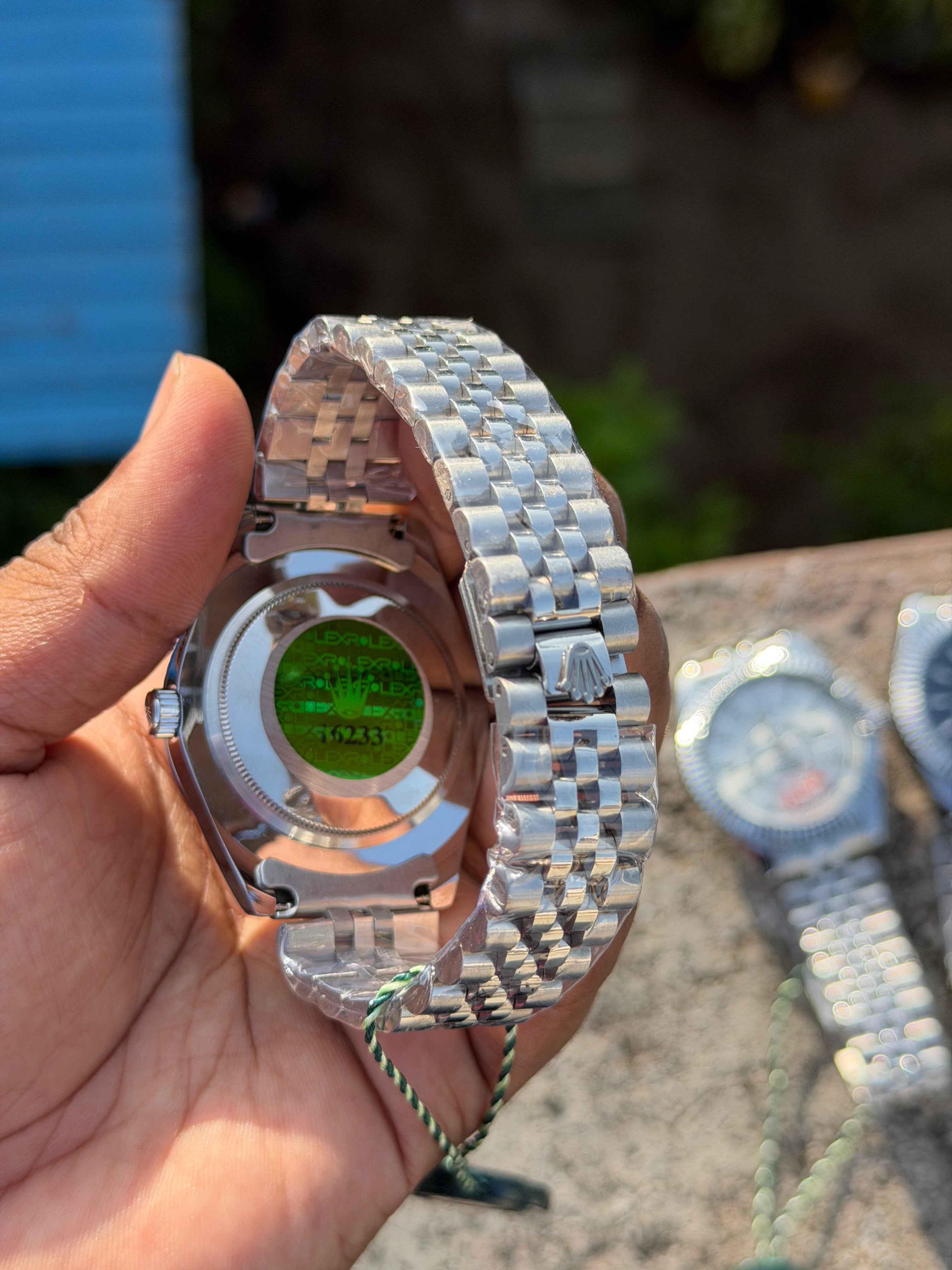 Rolex Sky-Dweller watch features a prominent fluted bezel and a black dial.