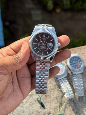 Rolex Sky-Dweller watch features a prominent fluted bezel and a black dial.
