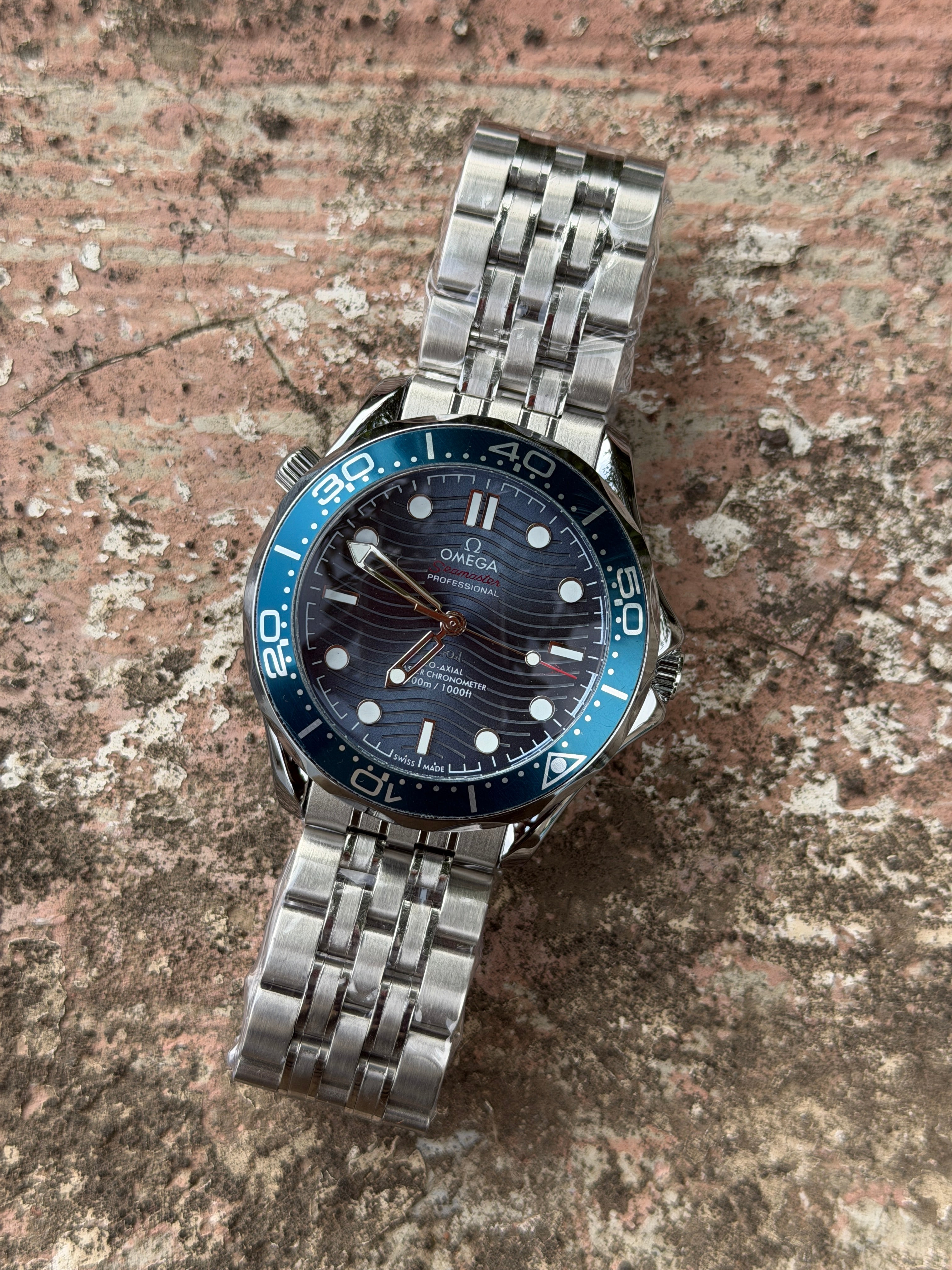 Omeg@ Seamaster Automatic Movement Diver 300M features a distinctive blue ceramic dial with laser-engraved waves- FC